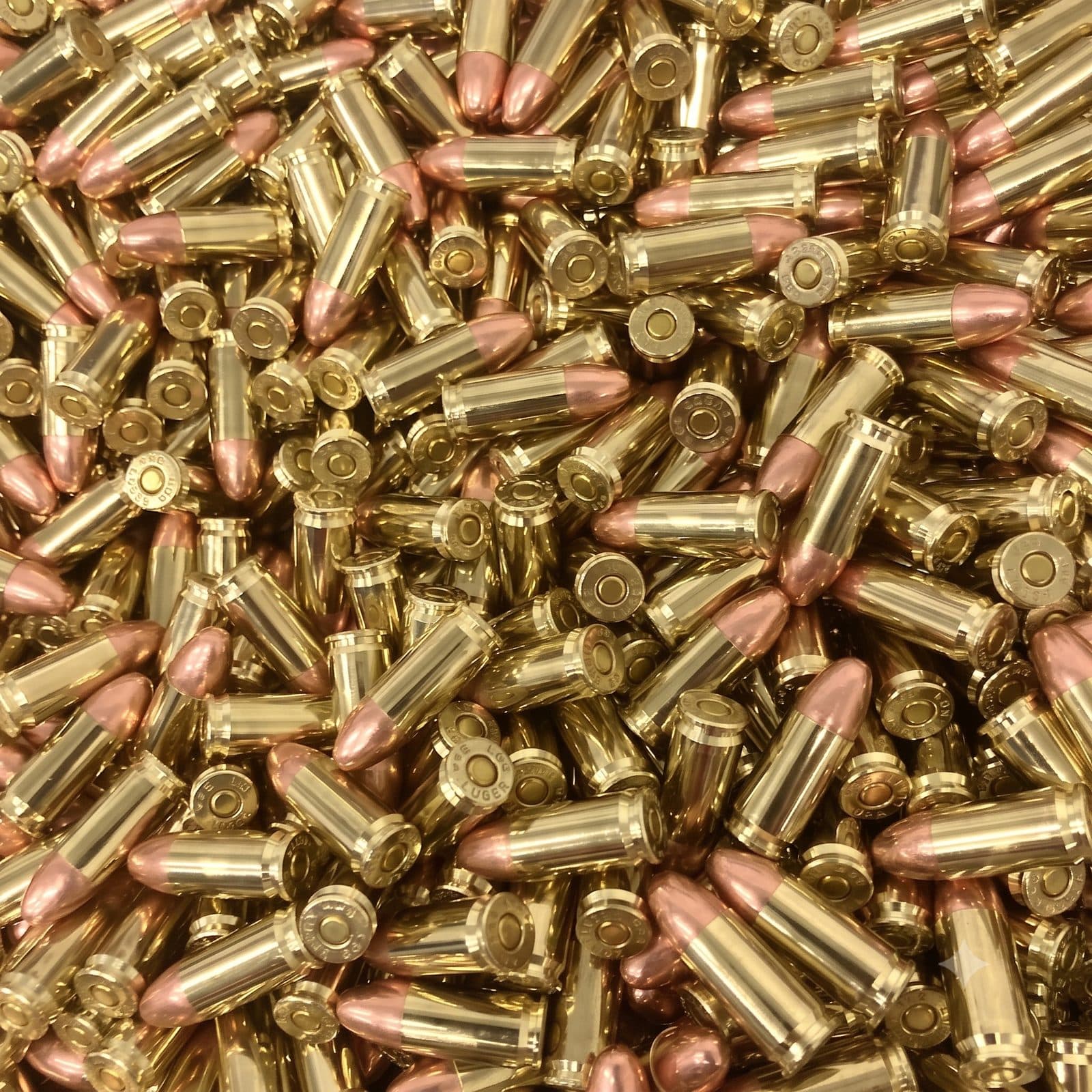 A bed of loose 9mm Luger cartridges, brass cases with copper full metal jacket bullets