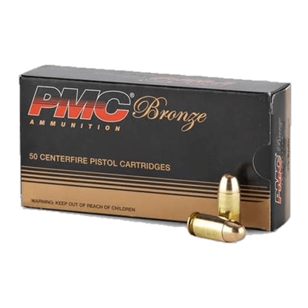 A black 50-cartridge box of PMC Bronze centerfire pistol ammunition, with two round-nose cartridges beside it